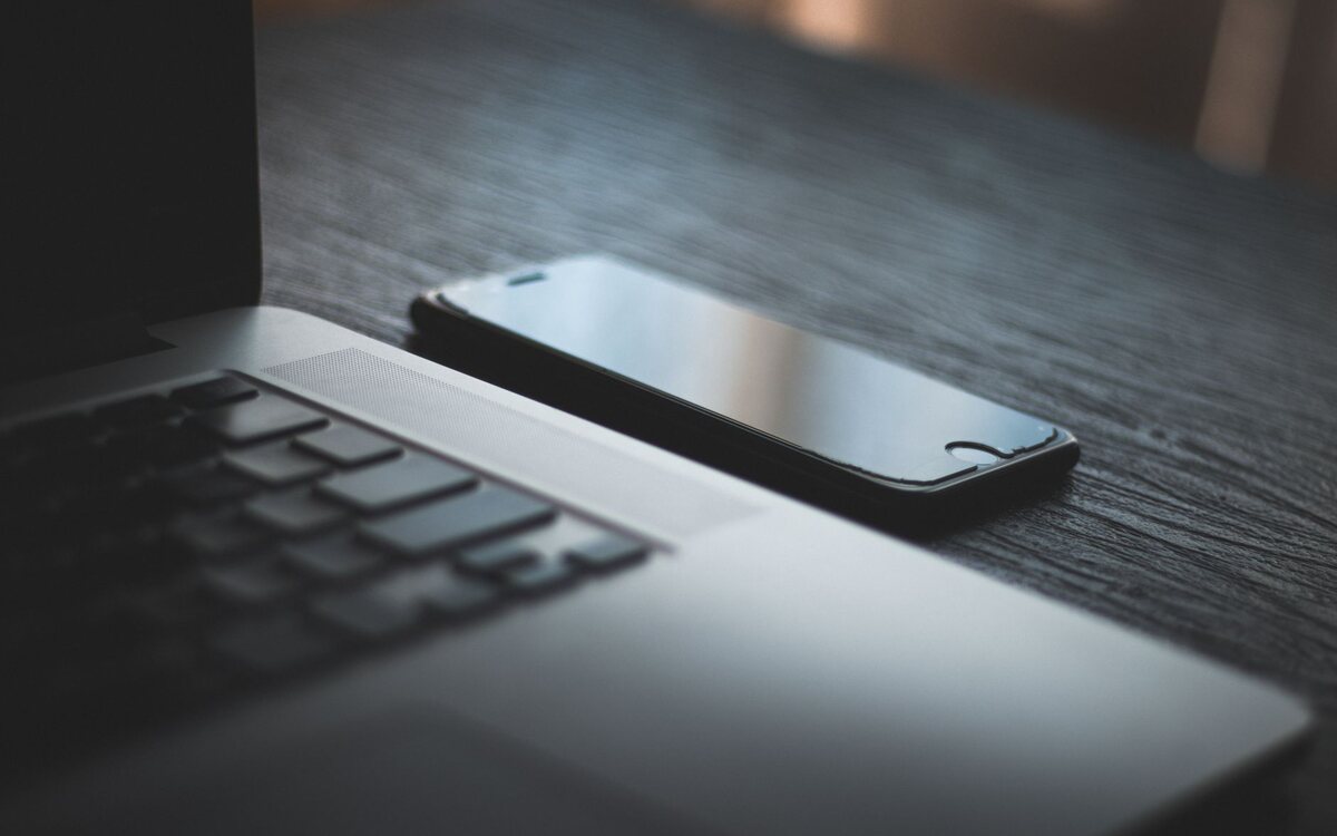 Notebook e celular sobre a mesa de trabalho